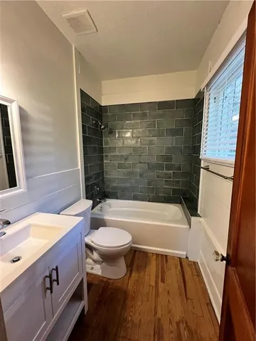 a bathroom with a sink a bathtub and shower