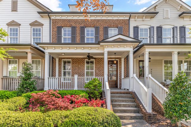 a front view of a house with a yard and outdoor seating