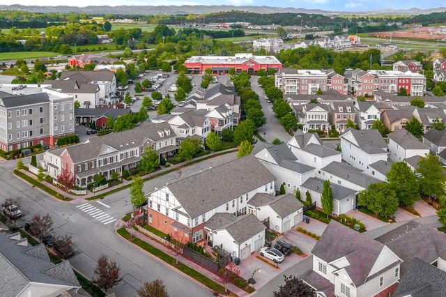 an aerial view of lake and residential houses with outdoor space