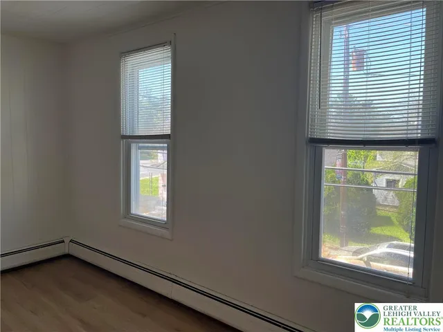 a view of a room with wooden floor