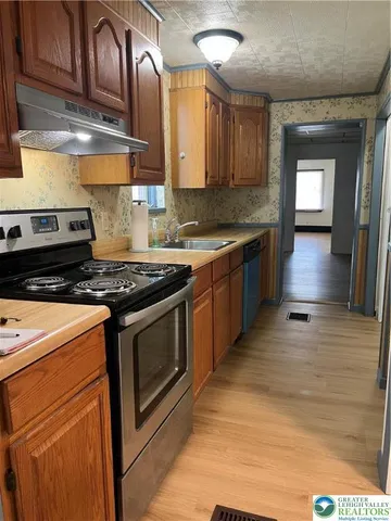 a view of a hallway view with wooden floor and furniture