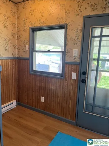 a view of a room with wooden floor