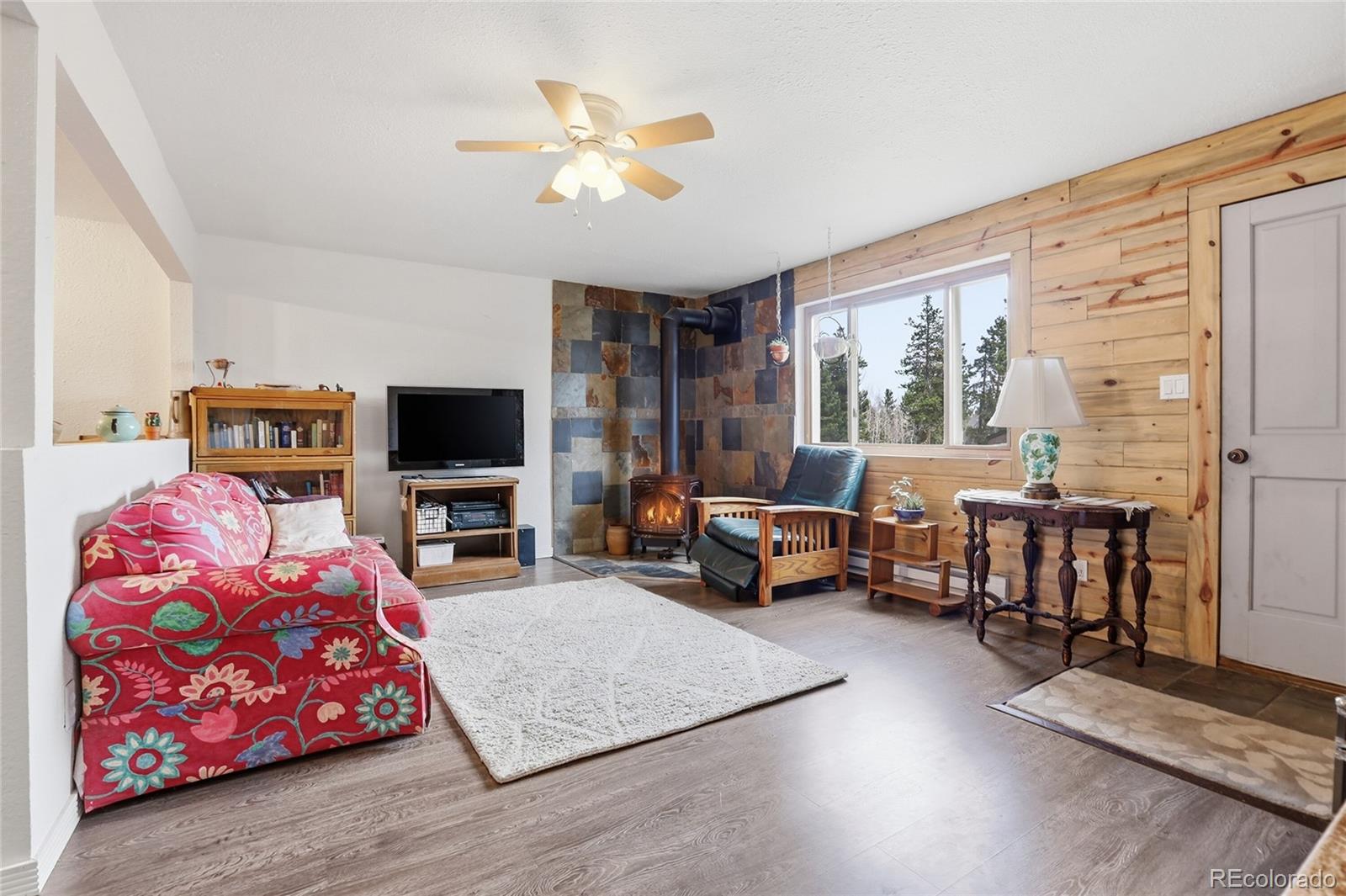 9225 Sandy Lane Conifer, CO 80433 - Photo 30 of 45 a living room with furniture and a flat screen tv