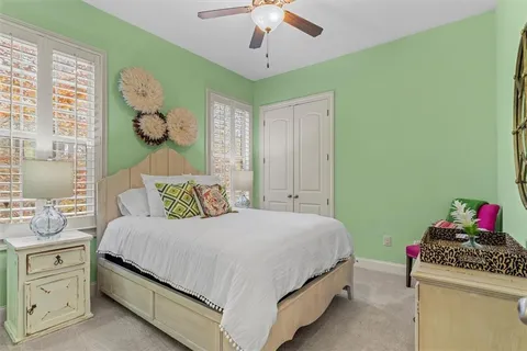 a bathroom with a granite countertop sink a toilet and a mirror