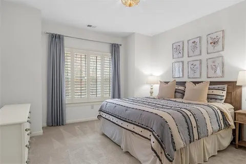 a bathroom with a granite countertop toilet sink and mirror