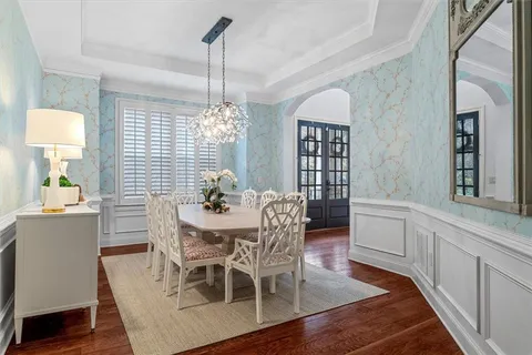 a view of a dining room with furniture and chandelier