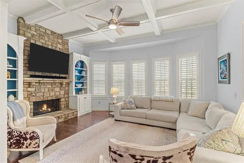 a living room with furniture a fireplace and a chandelier