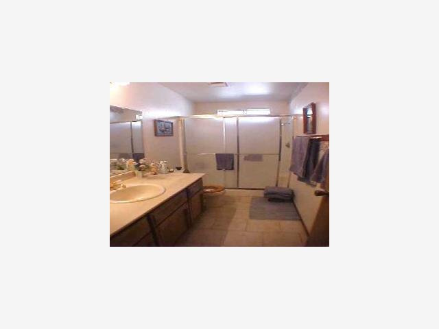2260 Roth Way Turlock, CA 95380 - Photo 5 of 8 a en suite bathroom with a sink and a mirror