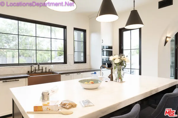 a kitchen with a table chairs and a window