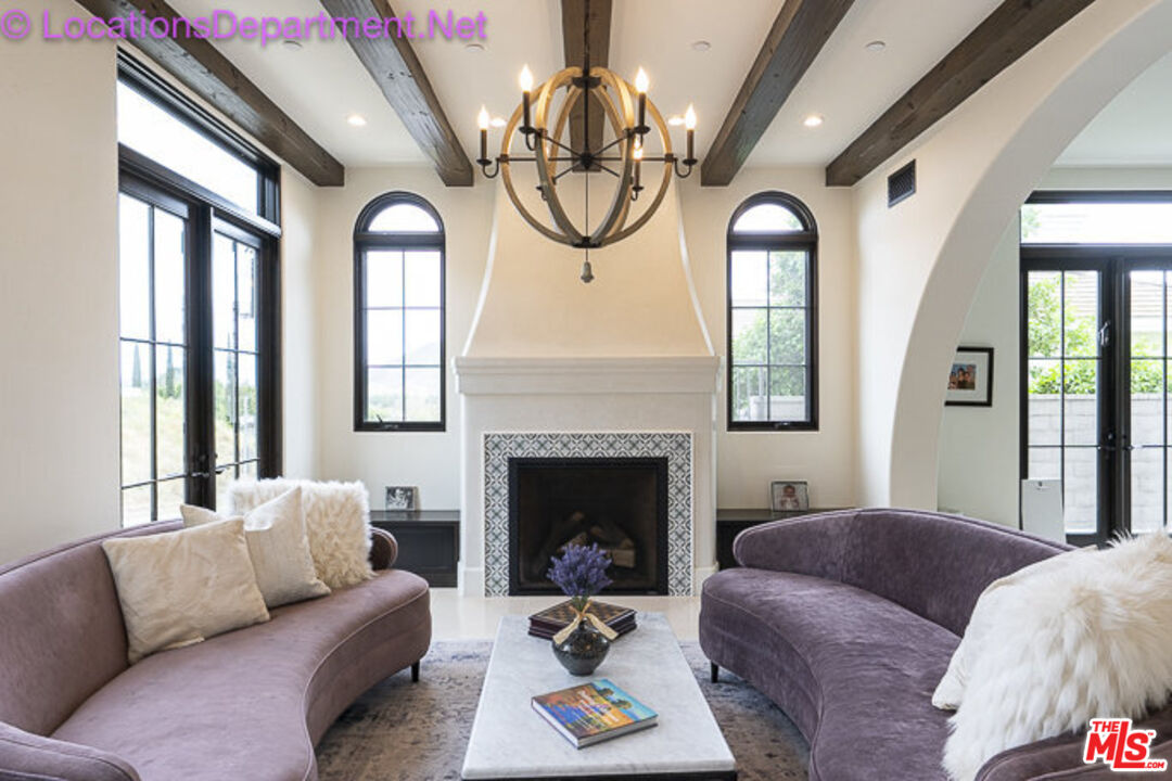 5861 Ridgebrook Drive Agoura Hills, CA 91301 - Photo 16 of 42 a living room with furniture chandelier and a fireplace