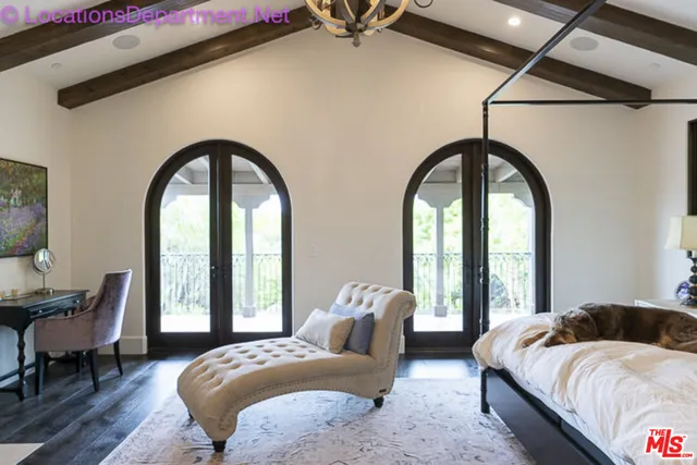 a bedroom with two beds and a large window