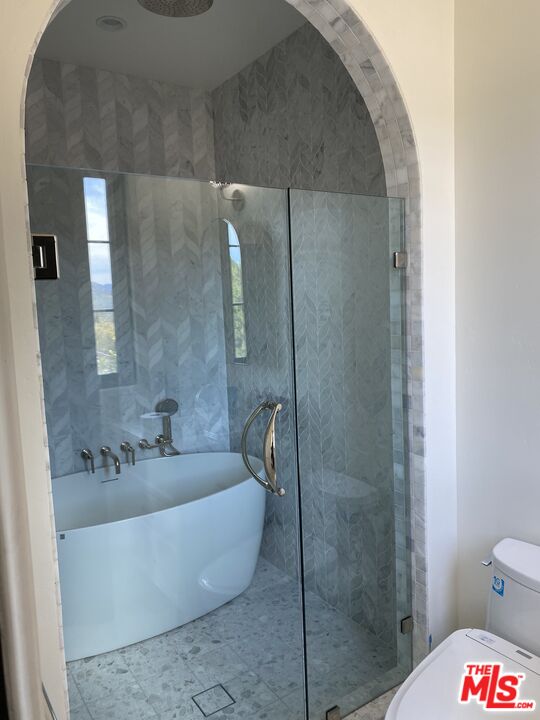 5861 Ridgebrook Drive Agoura Hills, CA 91301 - Photo 29 of 42 a bath tub sitting next to a white toilet and a shower