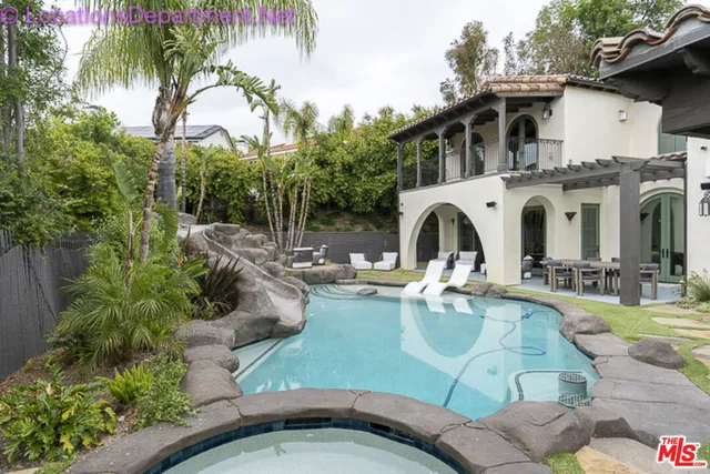 a view of a patio with couches table and chairs and potted plants