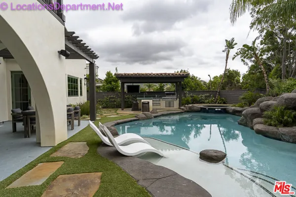 a view of a swimming pool with lounge chair