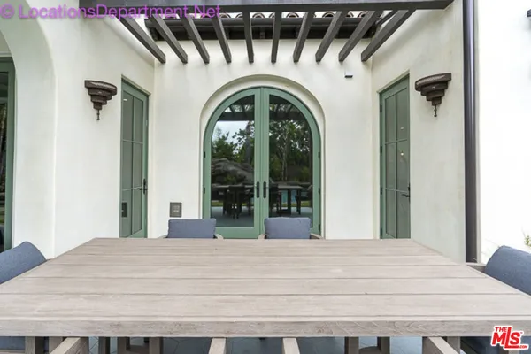 a large white door with a small yard