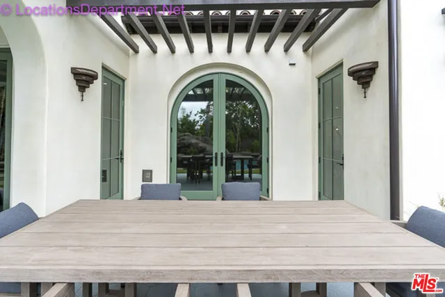 a large white door with a small yard