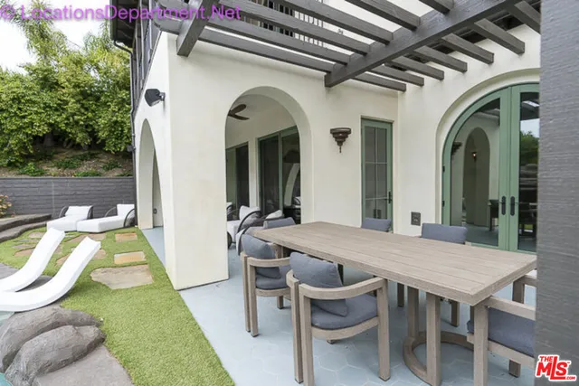 a view of a house with pool table and chairs