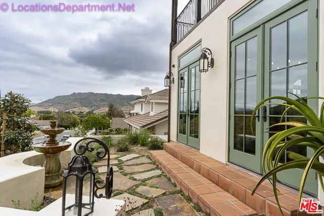 a view of a balcony with furniture