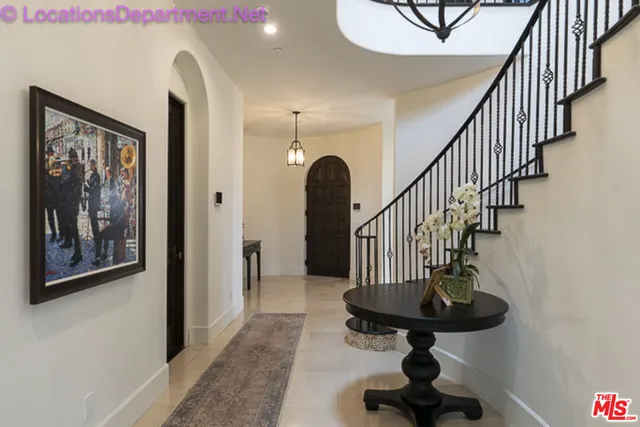 a view of staircase with wooden floor and a rug