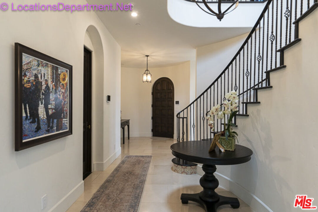 5861 Ridgebrook Drive Agoura Hills, CA 91301 - Photo 5 of 42 a view of staircase with wooden floor and a rug