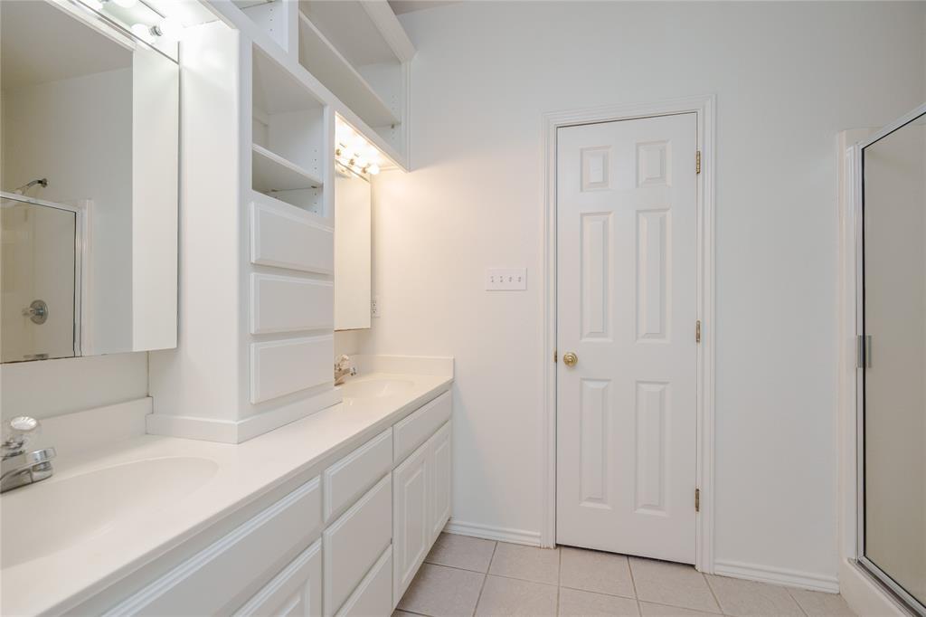 364 Parker Road, Unit A Van Alstyne, TX 75495 - Photo 21 of 39 Dual vanity with integrated sinks, white cabinetry, integrated shelving, and tile flooring