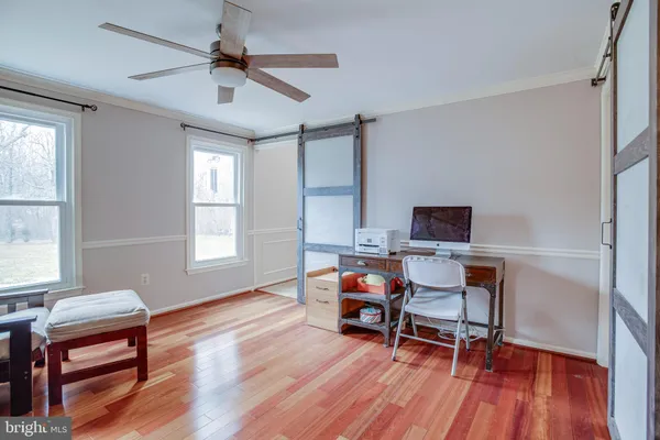 a view of entryway and hall with wooden floor