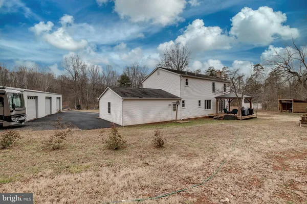 a view of a house with a yard and sitting area