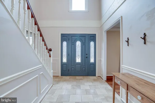 a view of entryway with wooden floor and stairs