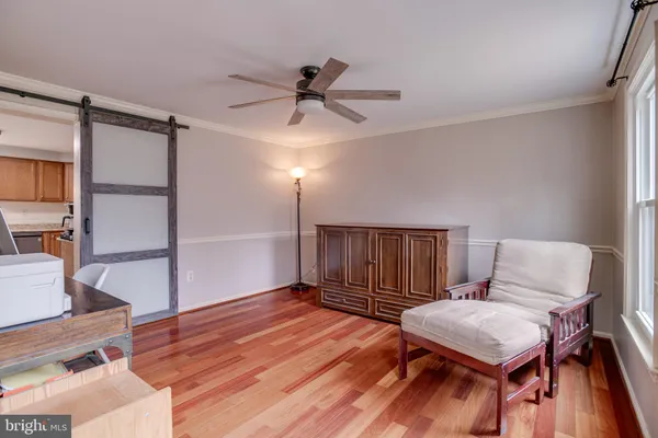 a work room with furniture and a wooden floor