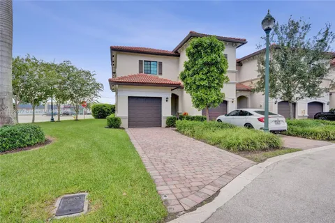 a front view of a house with a yard and a garage