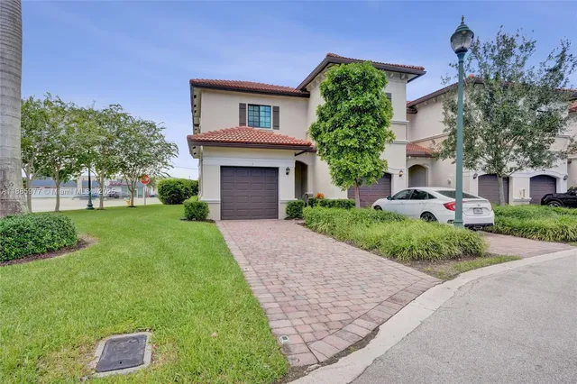 a front view of a house with a yard and a garage