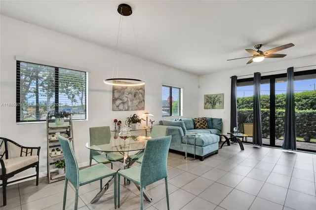a view of a dining room with furniture and a kitchen