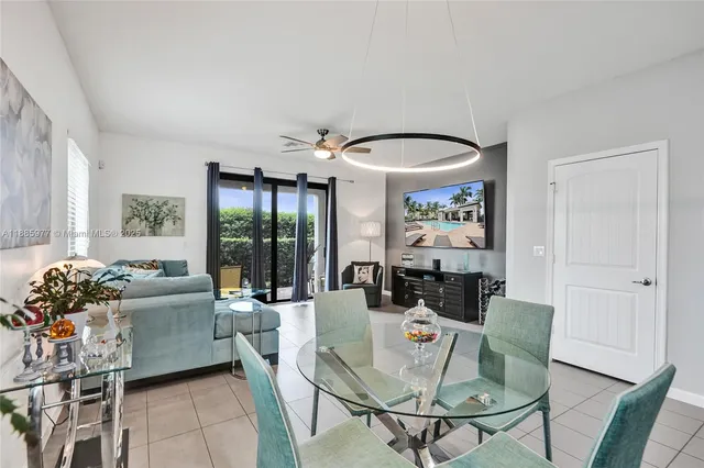 a kitchen with stainless steel appliances kitchen island granite countertop a refrigerator and a stove top oven