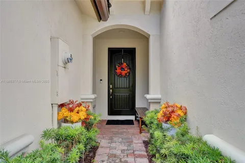 a front view of a house with flowers