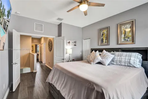 a bedroom with a bed and a painting on the wall