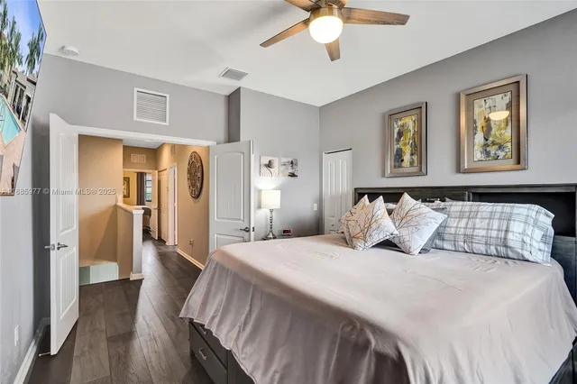 a bedroom with a bed and a painting on the wall