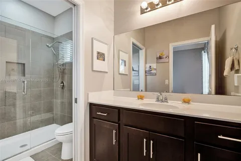 a bathroom with a sink a large mirror and a bathtub