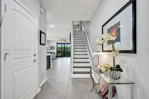 a hallway with dining table and chairs