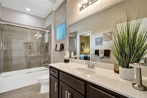 a view of a swimming pool and lounge chairs in patio with a lake view