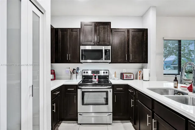 a kitchen with a sink stove and microwave