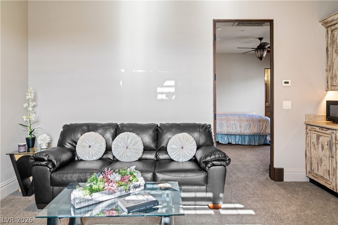 1123 Christian Road Henderson, NV 89002 - Photo 45 of 94 A versatile living space with plush carpeting offers comfort and direct access to a private bedroom area.