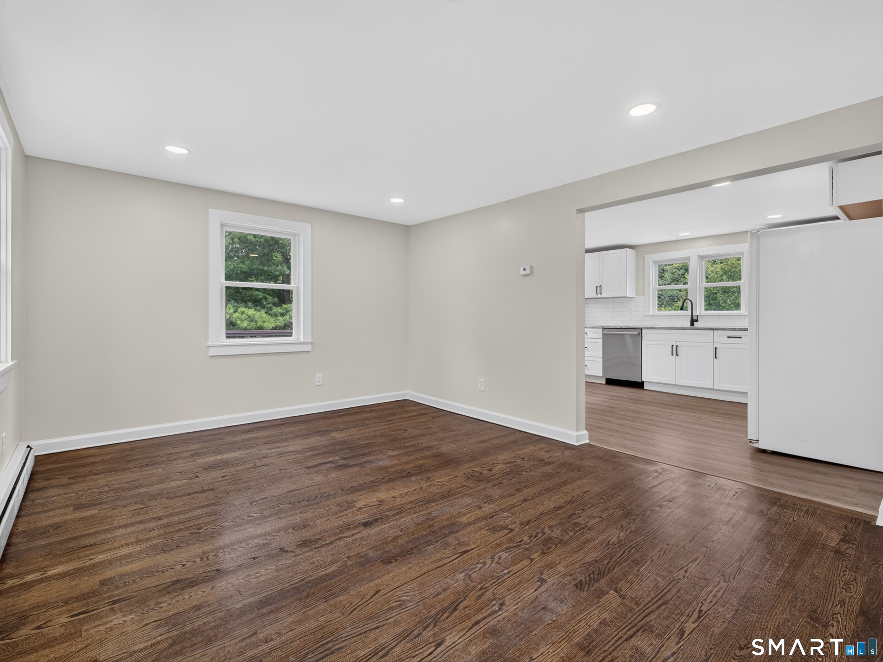 1039 N Road Groton, CT 06340 - Photo 7 of 26 a view of empty room with wooden floor and windows