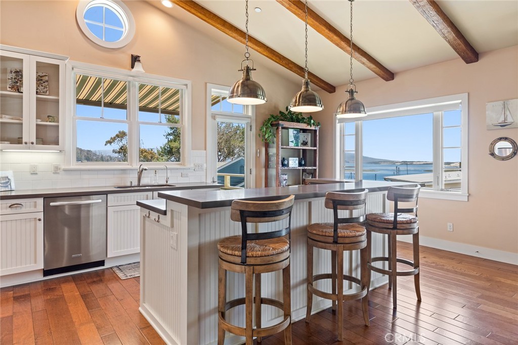 281 Main Street Morro Bay, CA 93442 - Photo 12 of 69 a kitchen with a table chairs stove and cabinets