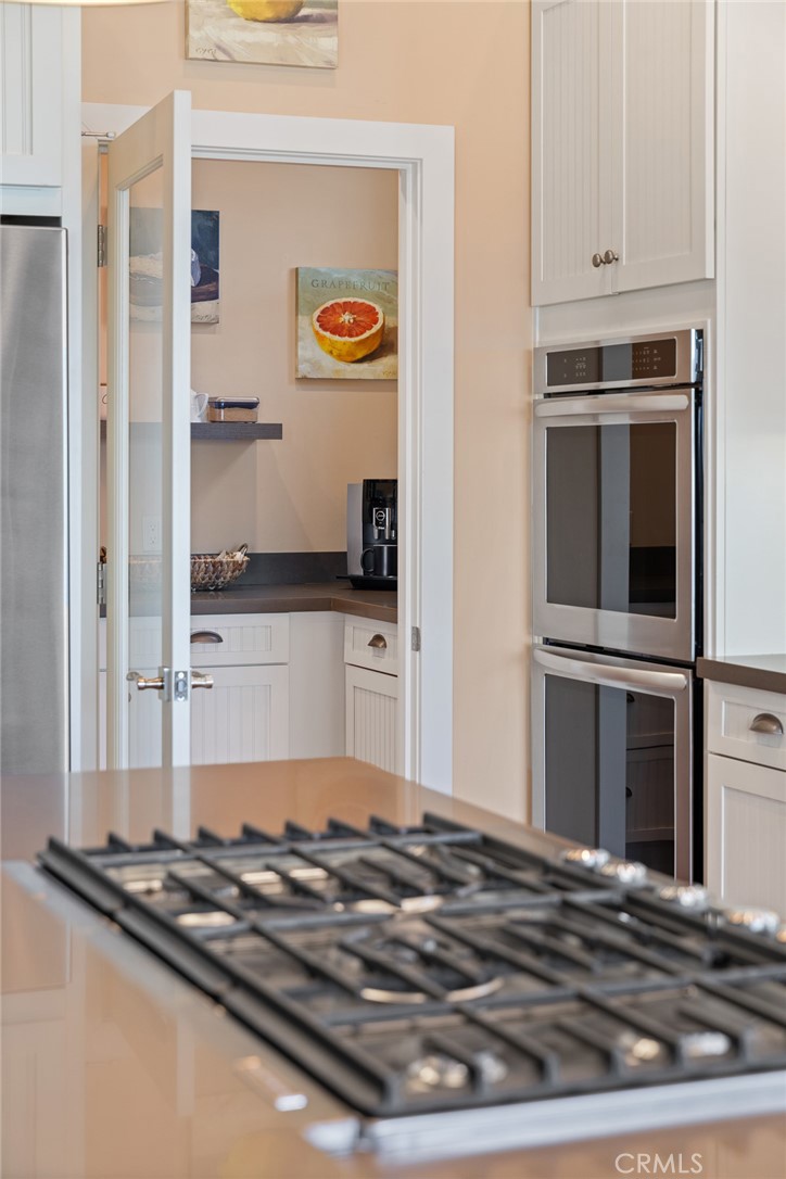 281 Main Street Morro Bay, CA 93442 - Photo 29 of 69 a kitchen with granite countertop a stove and a refrigerator