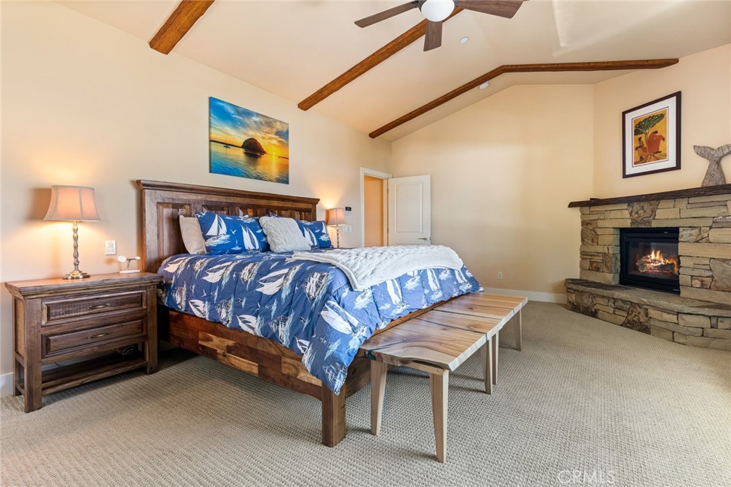 281 Main Street Morro Bay, CA 93442 - Photo 41 of 69 a bedroom with a bed and a fireplace