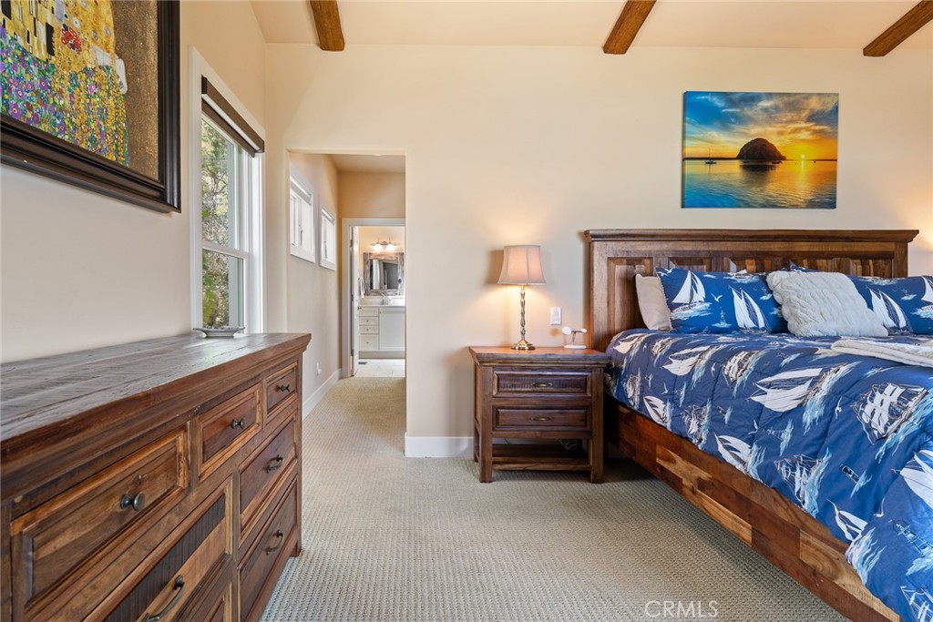 281 Main Street Morro Bay, CA 93442 - Photo 42 of 69 a spacious bedroom with bed and paintings on the wall