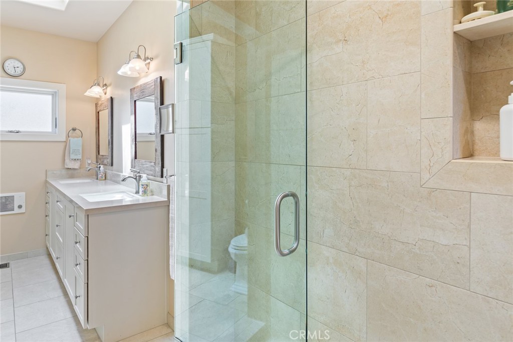 281 Main Street Morro Bay, CA 93442 - Photo 49 of 69 a bathroom with a double vanity sink mirror and shower