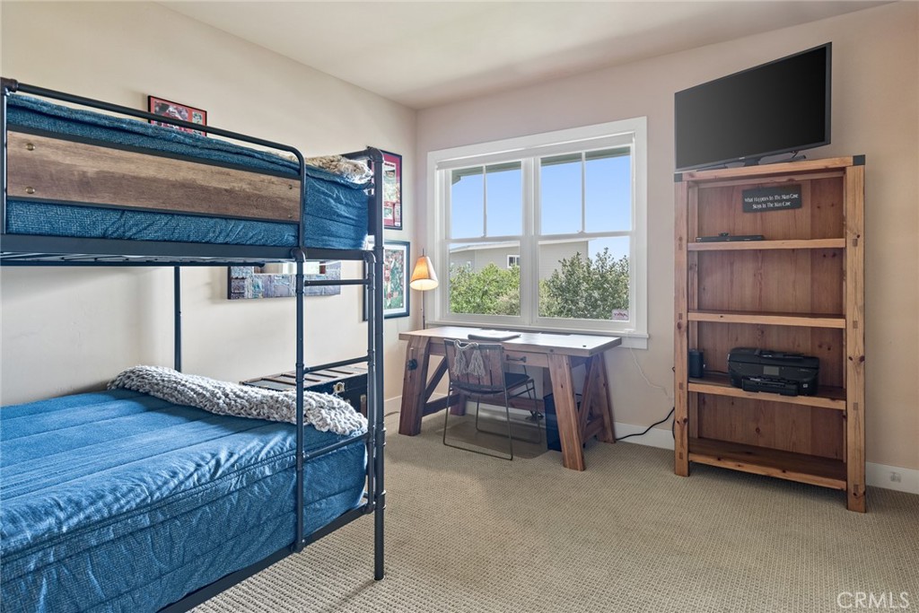 281 Main Street Morro Bay, CA 93442 - Photo 53 of 69 a bedroom with a bed a flat screen tv and a window