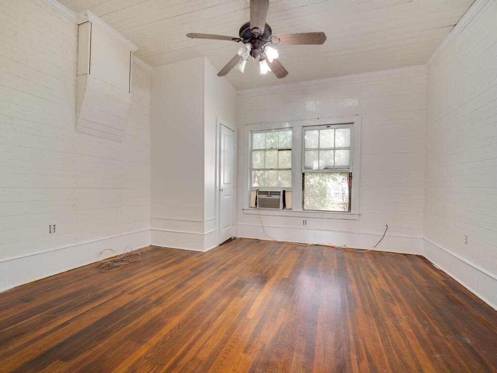 316 South Ave C, Unit B Elgin, TX 78621 - Photo 12 of 14 wooden floor in an empty room with a window