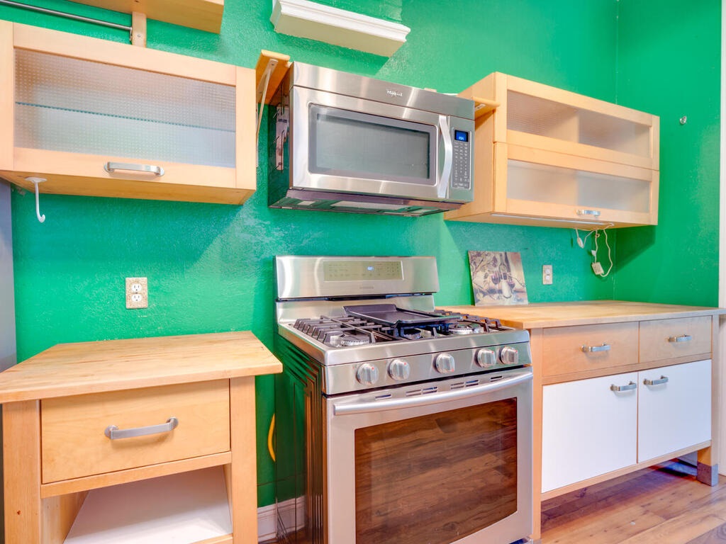 316 South Ave C, Unit B Elgin, TX 78621 - Photo 13 of 14 a kitchen with a stove and a microwave